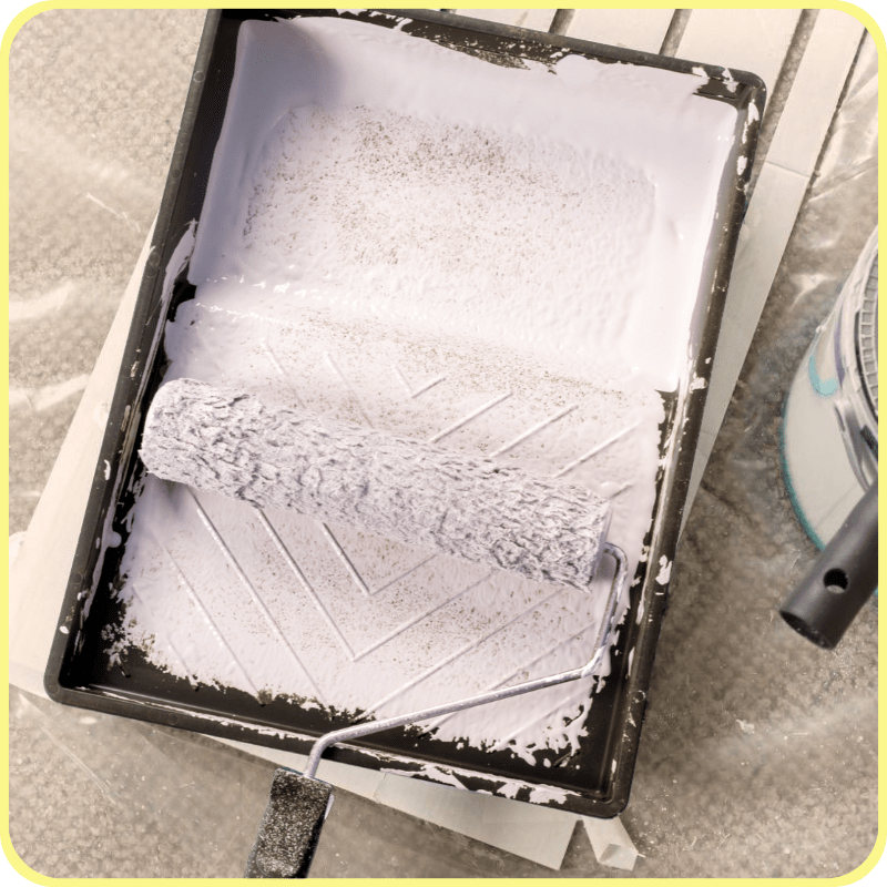 paint tray with paint and a paint roller